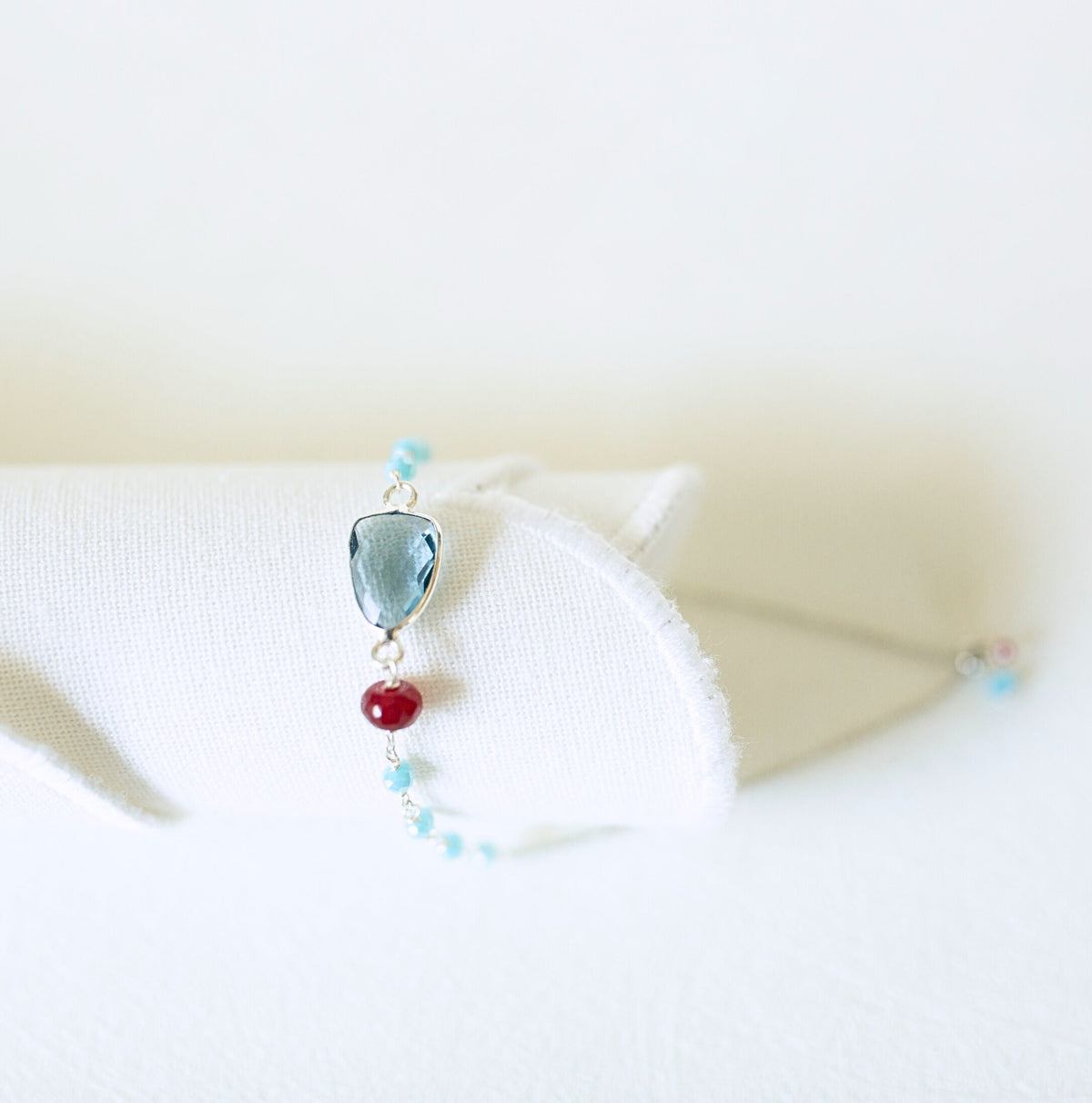 Blue gemstone Isla bracelet with silver-tone links and turquoise-colored bead accents.