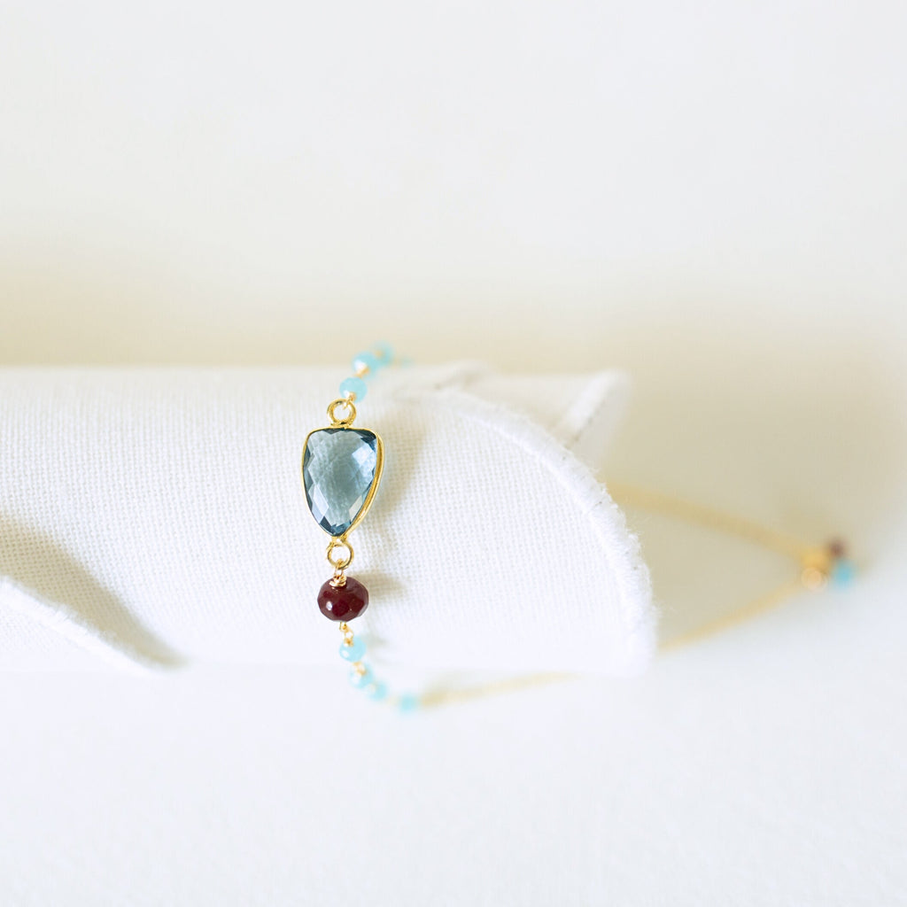Blue gemstone Isla bracelet with gold-tone links and turquoise-colored bead accents.