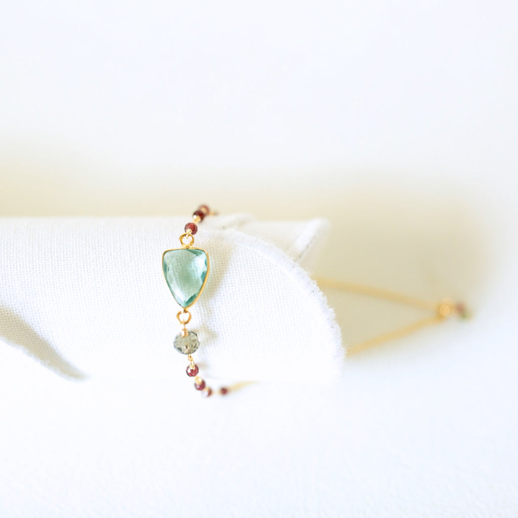 Pale green gemstone Isla bracelet with gold-tone links and small bead accents.