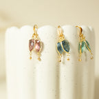 Pink, blue and pale green Isla drop earrings displayed side by side.