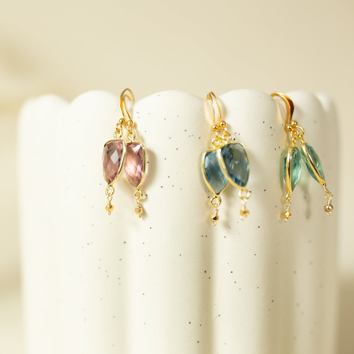 Pink, blue and pale green Isla drop earrings displayed side by side.
