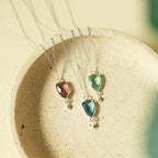Isla pendant necklaces with pink, blue and green stones on silver-tone chains.