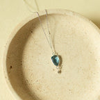 Blue faceted Isla pendant with a small drop detail on a silver-tone chain.