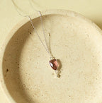 Pink faceted Isla pendant with a small drop detail on a silver-tone chain.