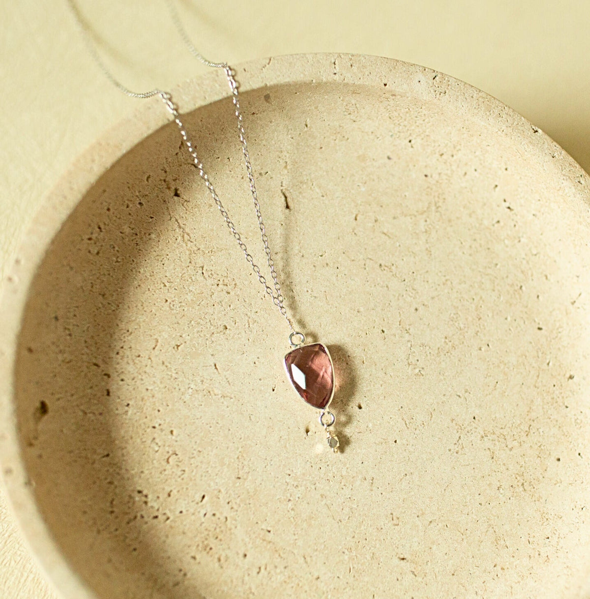 Pink faceted Isla pendant with a small drop detail on a silver-tone chain.