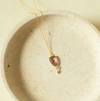 Pink faceted Isla pendant with a small drop detail on a gold-tone chain.