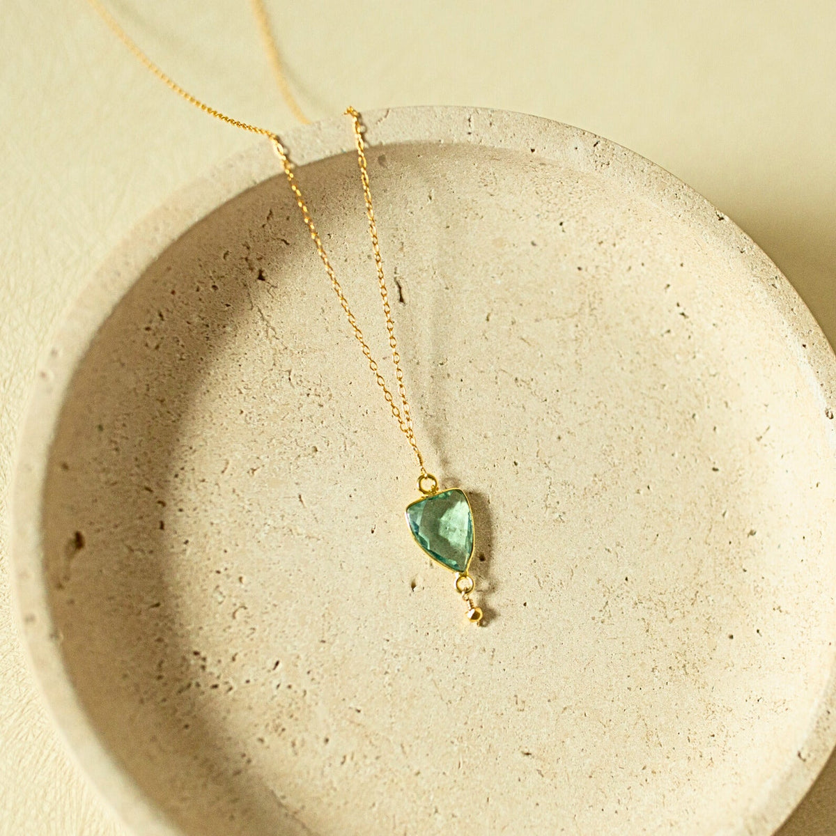 Pale green faceted Isla pendant with a small drop detail on a gold-tone chain.