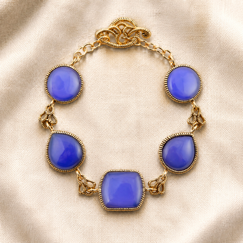 Blue agate stones in mixed shapes connected by ornate golden brass links