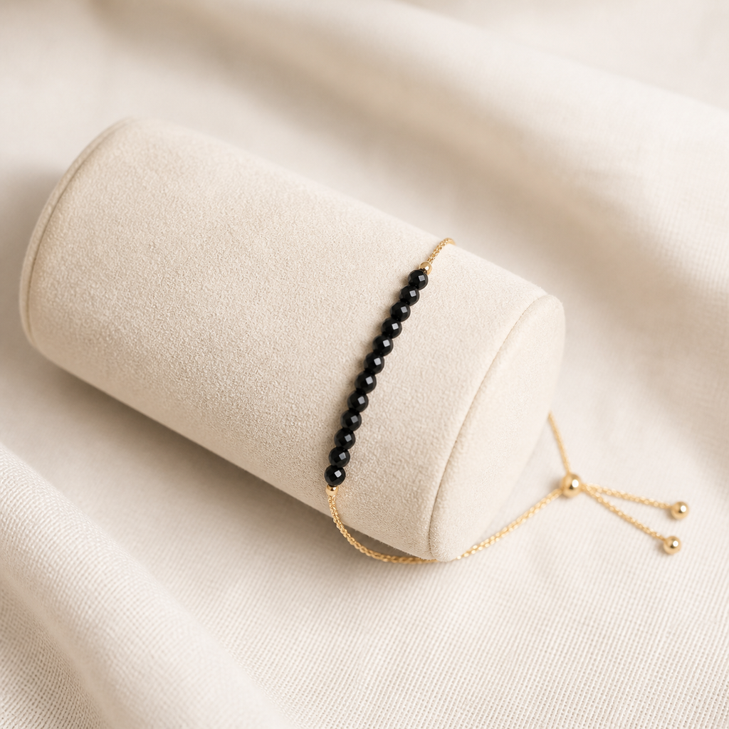 Black spinel beaded bracelet with a fine gold-plated sterling silver slider chain