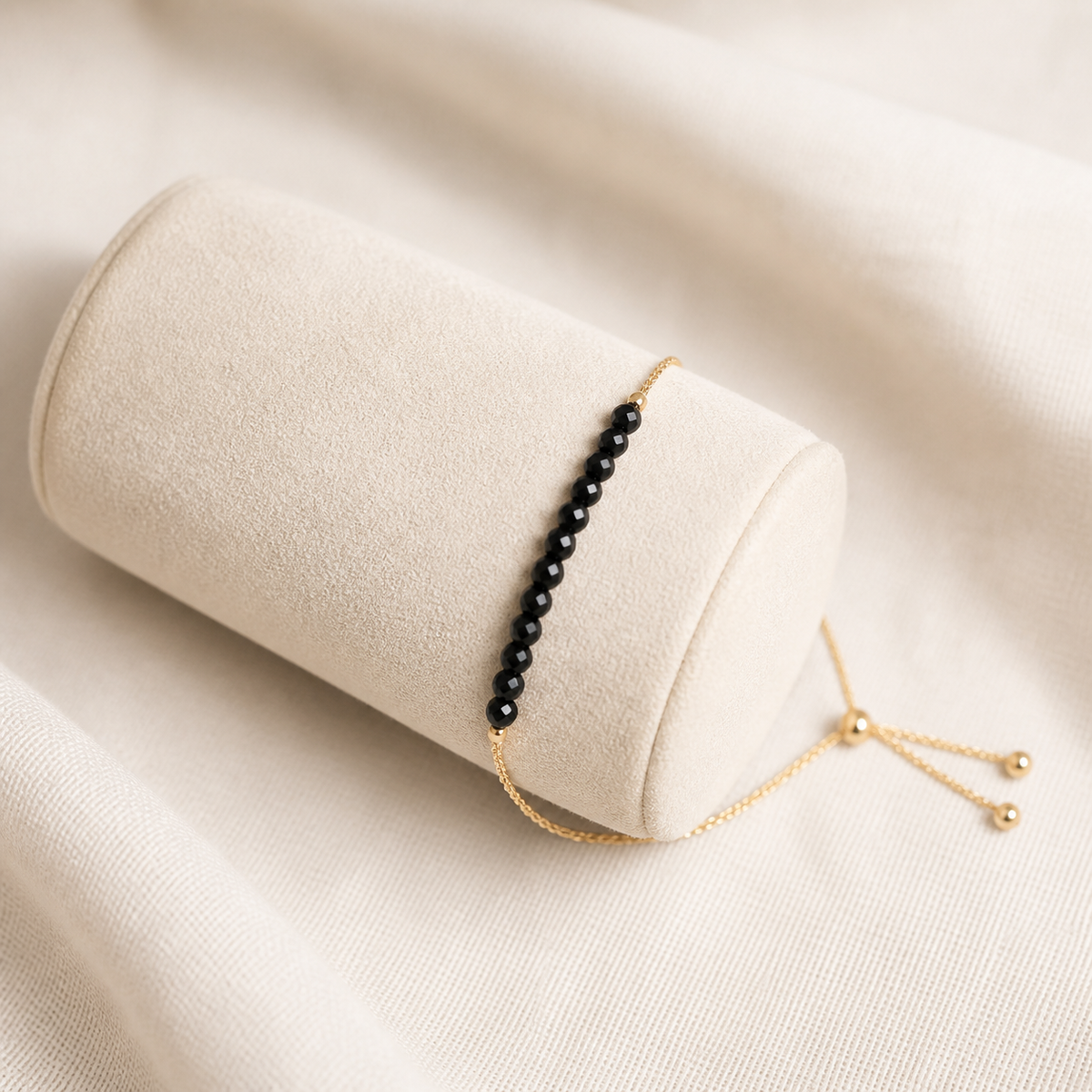 Black spinel beaded bracelet with a fine gold-plated sterling silver slider chain