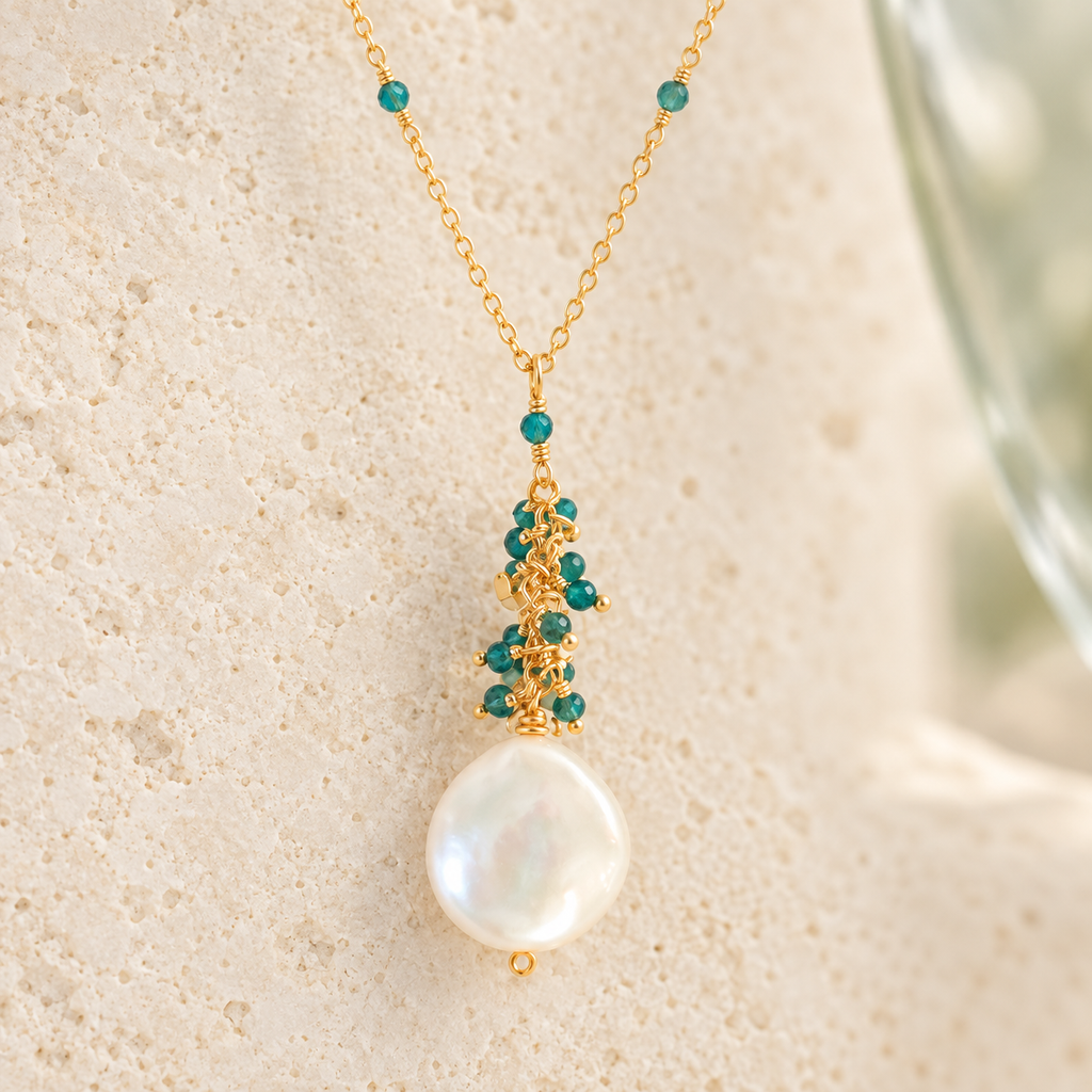 Marea Pendant in London Blue Quartz and gold-plated silver, with hand-wired gemstone accents and a freshwater coin pearl. AI-styled closeup; original detail photographs remain in the gallery.