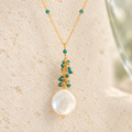Marea Pendant in London Blue Quartz and gold-plated silver, with hand-wired gemstone accents and a freshwater coin pearl. AI-styled closeup; original detail photographs remain in the gallery.