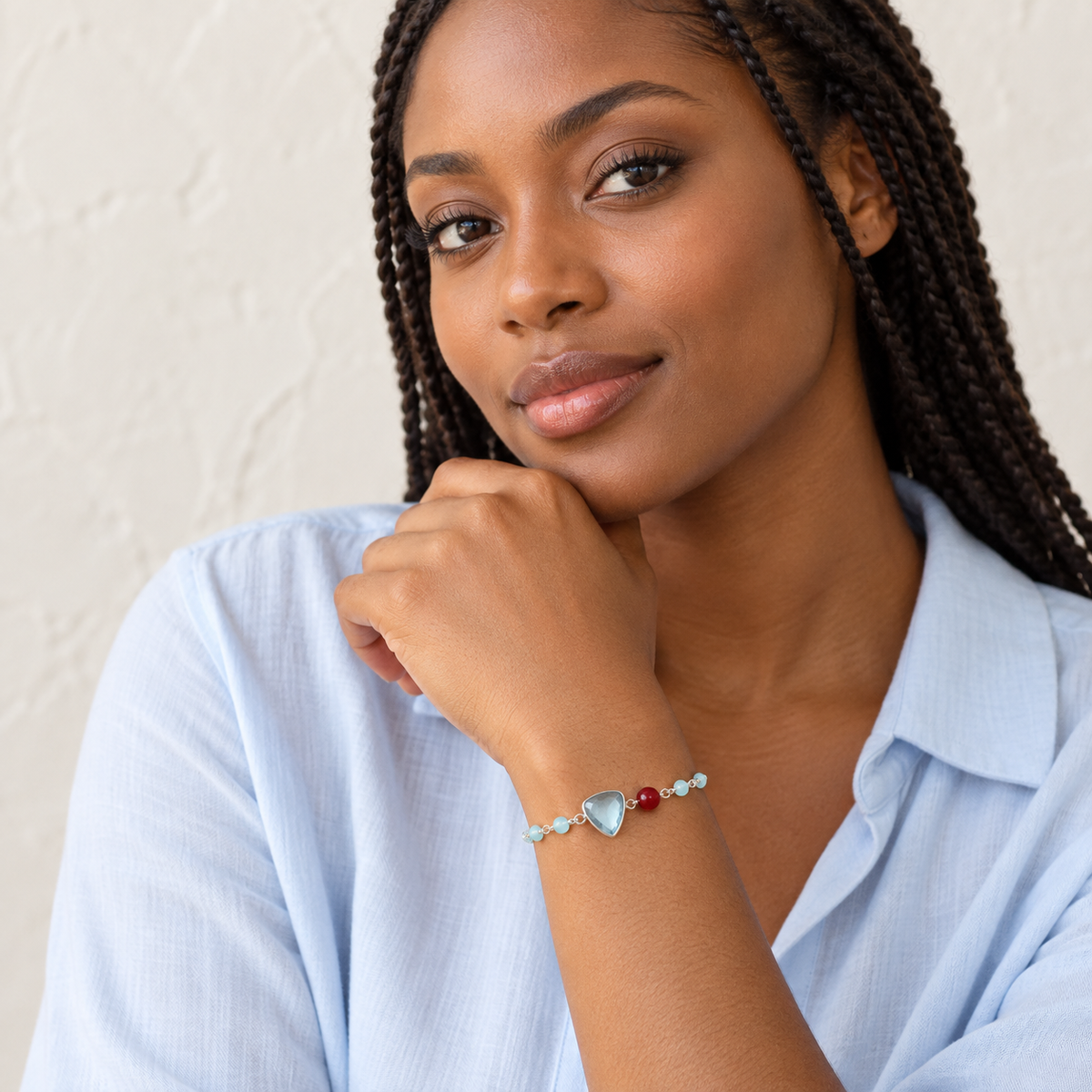 The Isla Bracelet — London Blue Quartz / Silver / Rhodium Plated styled on a model; AI-generated lifestyle image.