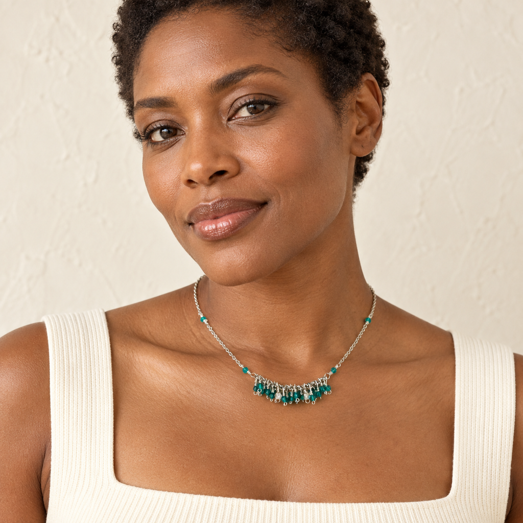 The Reign Necklace — London Blue Quartz / Rhodium / Silver styled on a model; AI-generated lifestyle image.