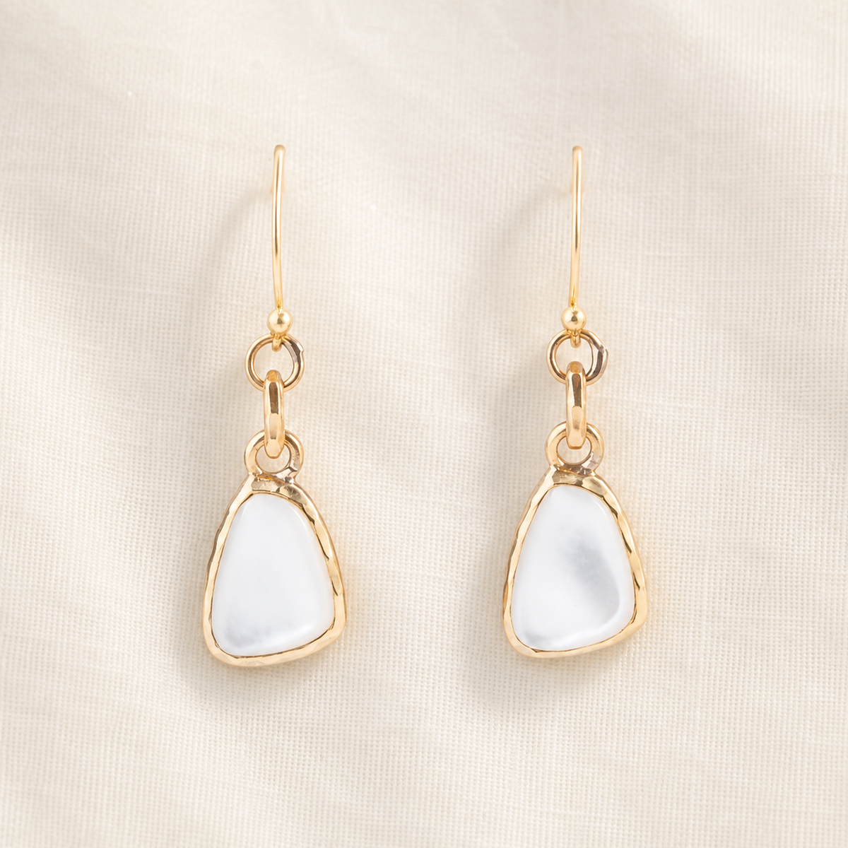White mother-of-pearl drops suspended from bronze links and ear wires