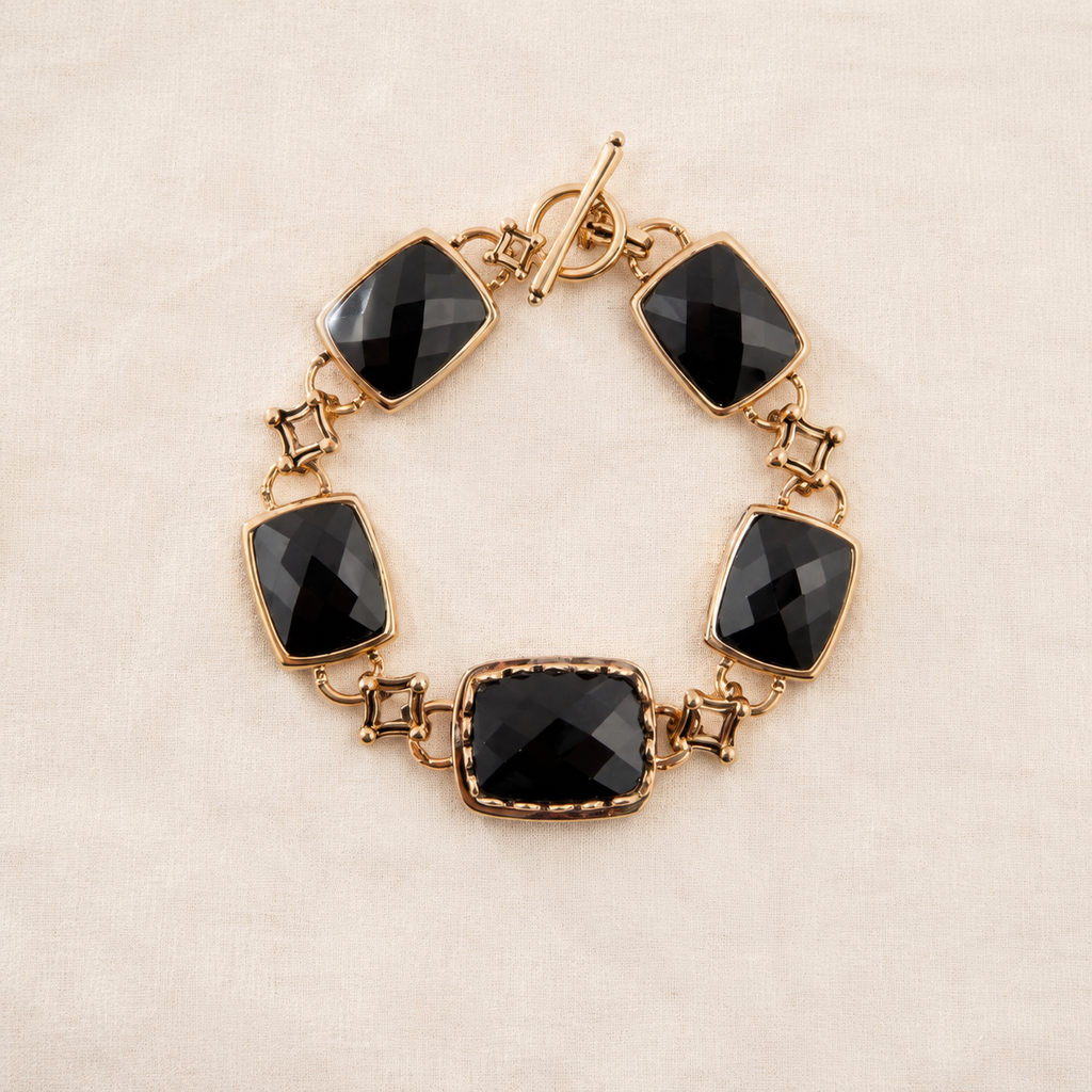 Five faceted black onyx stones in bronze links with a toggle closure