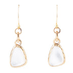 The Nacre Drops: front view of white mother-of-pearl earrings in bronze bezels with linked connectors and hook ear wires.